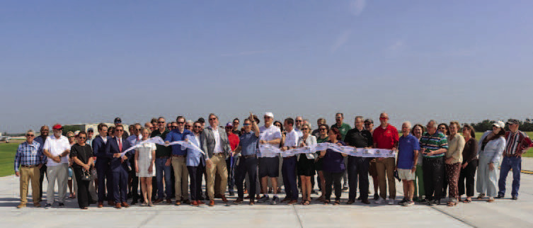Airport officials, elected leaders and community members celebrate the completion of the Guthrie Edmond Regional Airport Taxiway Realignment Project during a ribbon cutting on the newly constructed taxiway June 30. Photo courtesy of the City of Guthrie.
