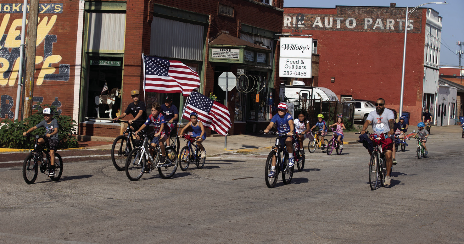 Patriotic participants ride decorated bicycles through Guthrie during the seventh annual Freedom Ride. Photo by Brent Fuchs