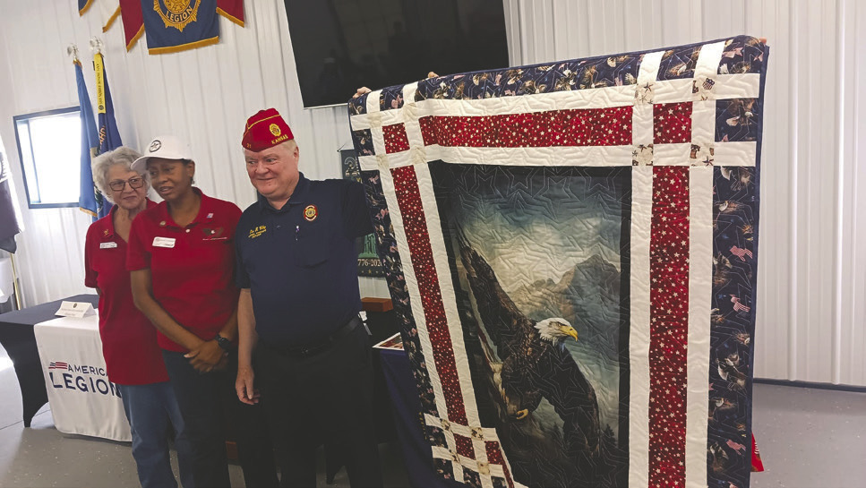 National American Legion Commander Dan Wiley, center, receives a handmade Quilt of Honor from members of Quilts of Honor Oklahoma during his visit to Lebron American Legion Post 58 in Guthrie. The quilt was presented in recognition of Wiley’s military service and dedication to America’s veterans. Submitted photo
