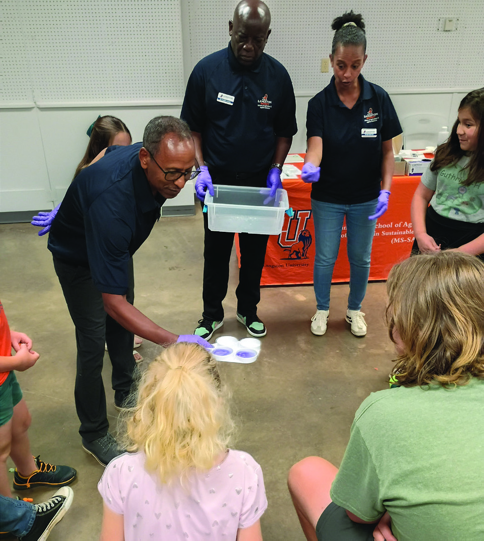 Hands-on learning was part of Logan County 4-H's Dairy Education Day as participants reviewed sample results.