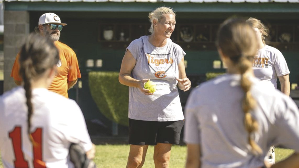 Crescent softball head coach addresses the team during practice as the Tigers prepare for the start of the upcoming season.