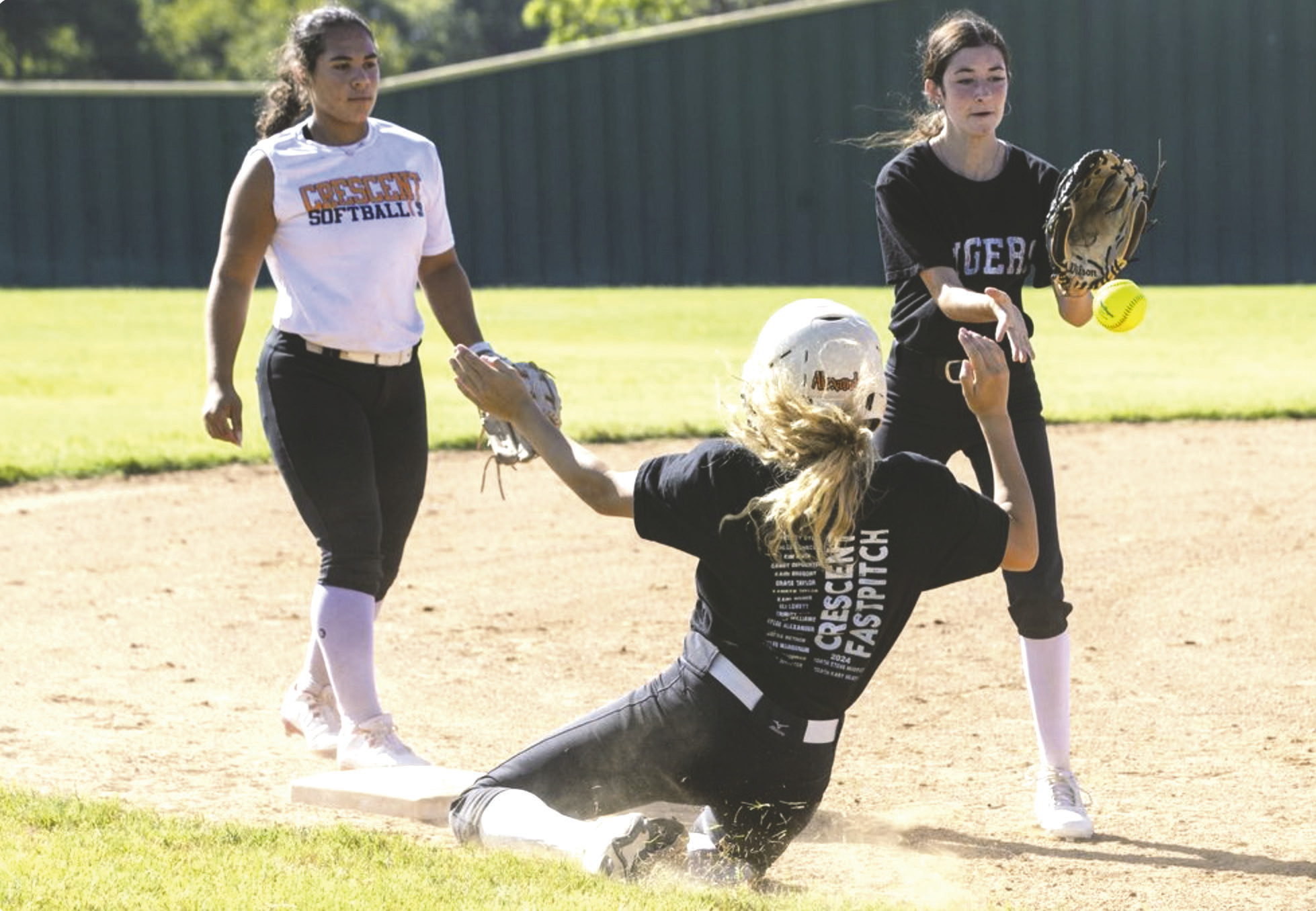 Members of the Crescent softball team work through drills during a preseason practice