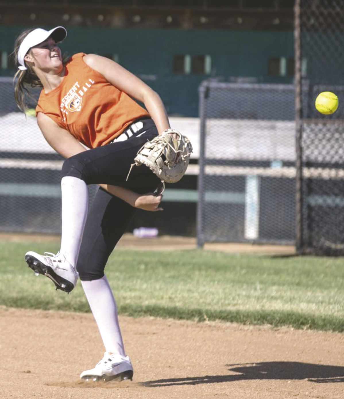 Practice isn't all serious business as a Crescent softball player flips the ball under her leg between drills, keeping the mood light while preparing for the season.