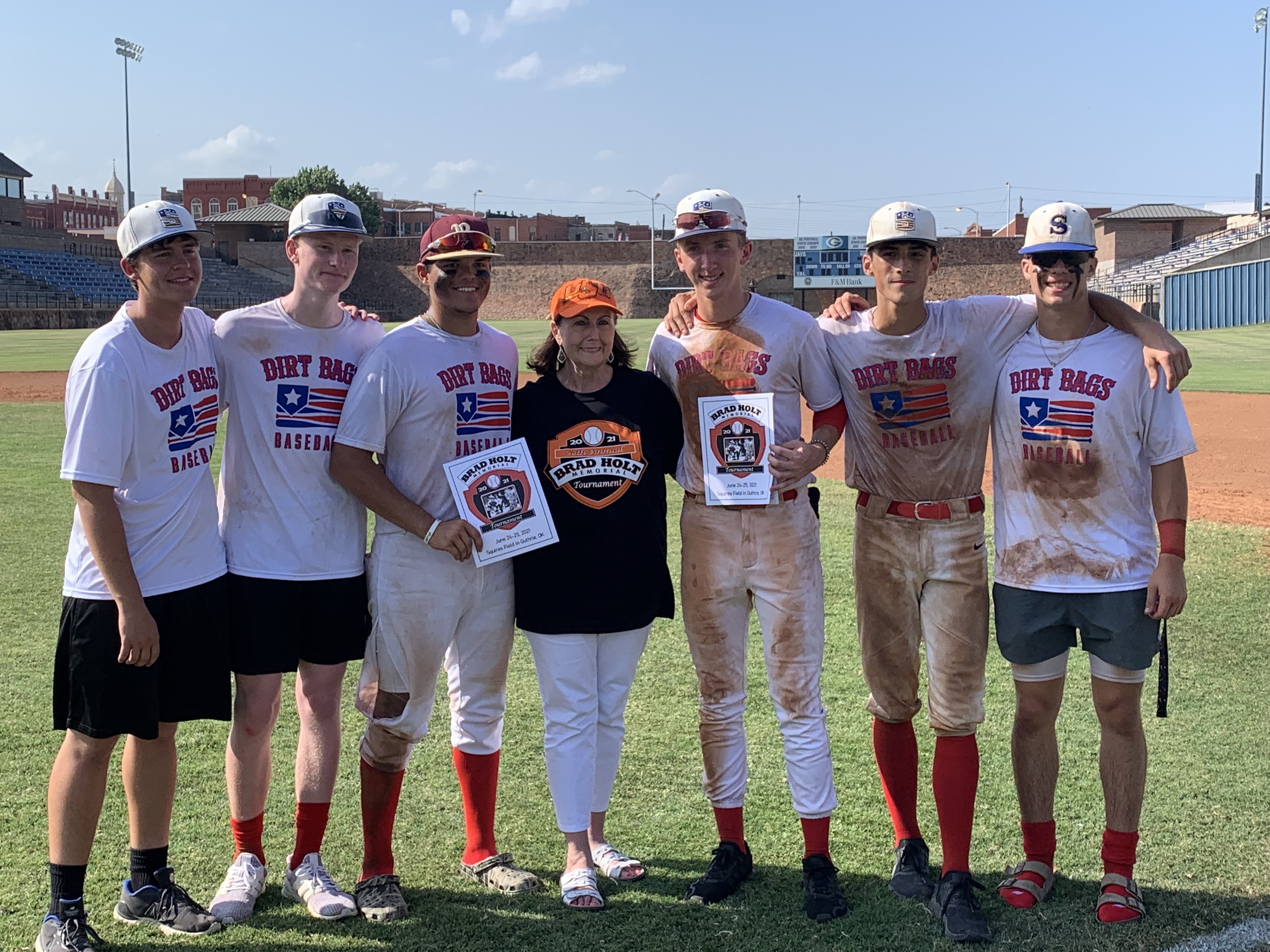 Members of the 2021 Brad Holt Memorial Tournament Champion Oklahoma Dirt Bags pose with Becky Holt. The Dirt Bags went 3-0 with a run differential of plus 26.