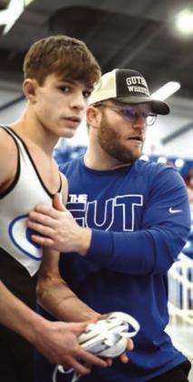 Coach Jadon Davenport with Dax Lopez at District meet.