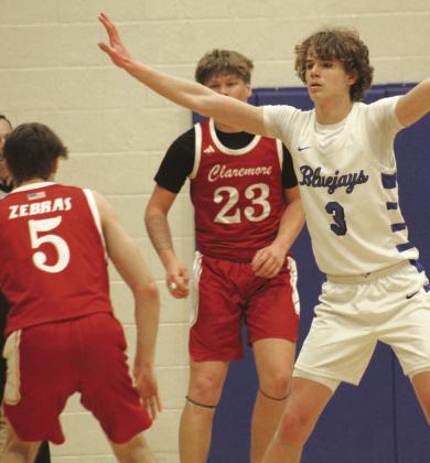 Guthrie's Kolson Smedley plays defense against Claremore, Jan. 31. Photo by George McCormick.