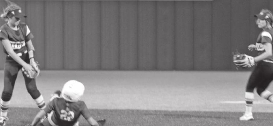 Saige Driscoll goes to apply the tag on a stolen base as McKenna Tucker backs the play up