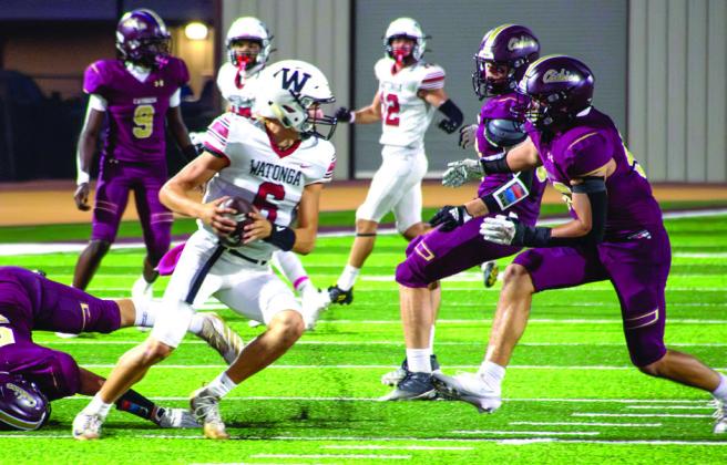 Cashion’s defense swarms Watonga quarterback Boomer Mendenhall during the Wildcats’ 42-7 rout Friday night.