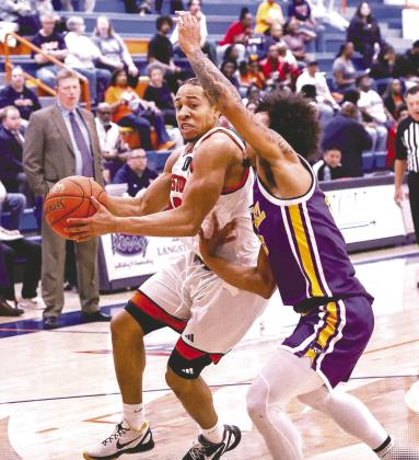 A Langston player drives past an Eastern Oregon defender during the basketball game on March 14. Photo courtesy Langston University Facebook page