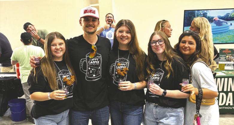 A group of attendees samples craft brews during the sixth annual Hoppy Camper fundraiser at Camp Twin Cedars in Guthrie. Photo Cody Lawson