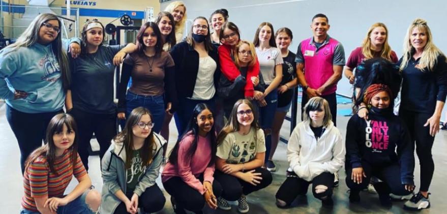 McCoy poses for picture with Guthrie students after sharing his story of overcoming opioid addiction