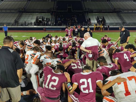 OCA and Crescent players gather for a postgame prayer