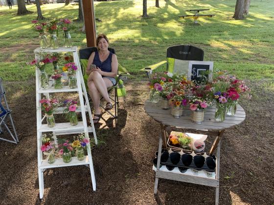 Debbie Norrid helped out last summer at the cut flower booth of her sister, Susan Snyder. (Photo provided by Susan Snyder)