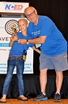 Danny Cavett, founder of Cavett Kids Foundation, with camper Grace Nelson