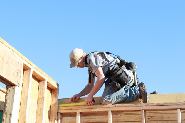 Stillwater senior, Hollis Mayfield, measures a beam at the house the Meridian Carpentry Program is building.