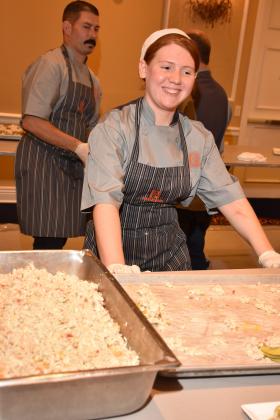 Jazlyn Hancock, a Meridian Culinary Arts student from Guthrie, works behind the scenes plating food at the Odyssey de Culinaire. Photo courtesy of Tracy Reece with Smile Time Photo Booth.