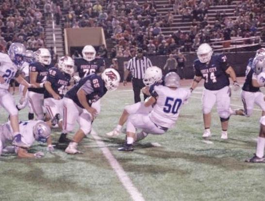 Guthrie's Nathan Ruhman (number 50) makes a tackle against Ponca City. He will play for Mike Gundy and the Oklahoma State Cowboys this fall.
