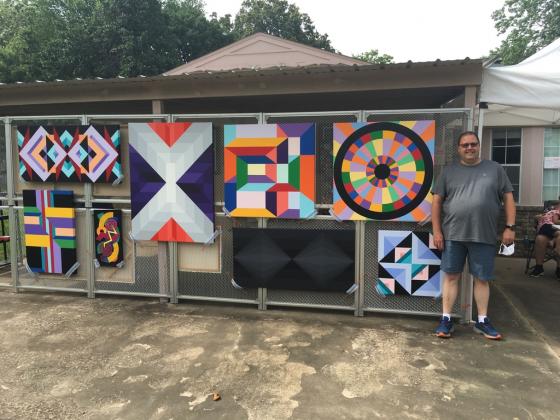 Jason Wilson, photo of artist in driveway with art during OK Art Crawl 2020