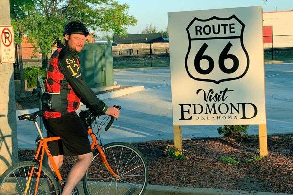 Cyclist by Route 66 sign
