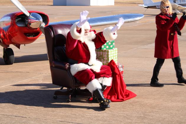 Santa seated as kids make their way to him.