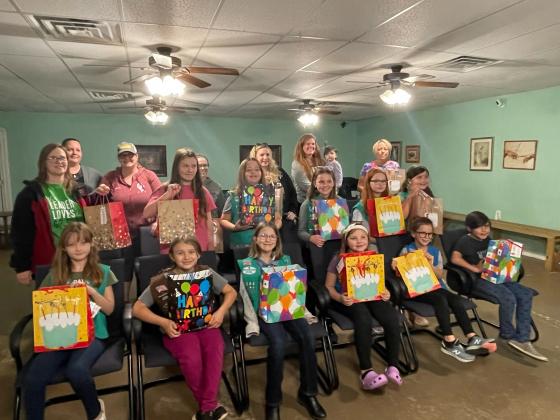 Girl Scout Troop 3005 donates 15 birthday bags to Hands of Jesus  in Guthrie. Birthday bags consist of cake mixes, icing, Birthday decorations and a small gift to brighten a Birthday child's day that might not be able to celebrate.