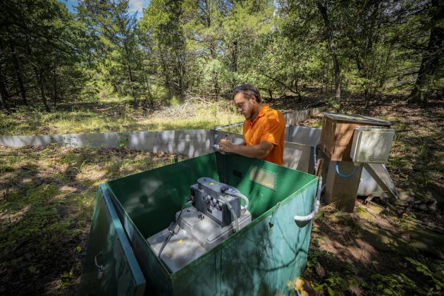 Graduate students with the Oklahoma Water Resources Center conduct research to improve water quality and sustainability throughout the state. Austin Phillippe monitors the water quality of runoff at the Cross Timbers Experimental Range. (Photo by Todd Johnson, OSU Agricultural Communications Services)