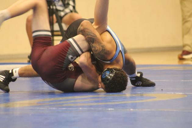 Guthrie's Kaedin Herendeen wrestles with Perry's Tucker Vollmer in Thursday's dual, Thursday, Dec. 5.