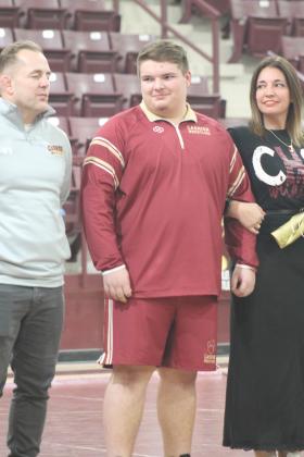 Cashion wrestling senior Matthew Stockton with his family on senior night. Taken by George McCormick.
