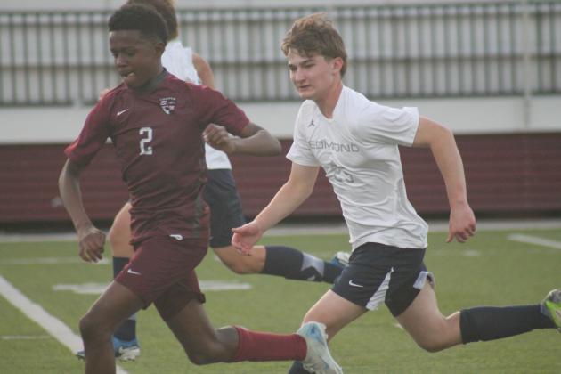 Edmond Memorial's Braylin Jones races an Edmond North defender to the ball, Wednesday, March 12. Taken by George McCormick.