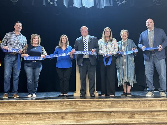 Collateral Elementary Schools opens its doors with a ribbon cutting ceremony on the evening of Thursday, March 13, 2025. Left to Right: Chris Schroder, Tina Smedley, Janna Pierson, Mike Pierson, Leslie Cotton, Gayle Davis, Ron Plagg. Photo by Bobbi Waddell