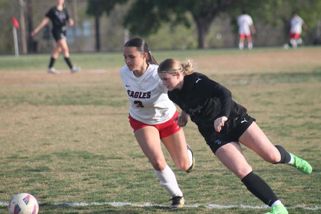 Guthrie's Payton Rolens fights for a ball against Del City, March 31. Taken by George McCormick.