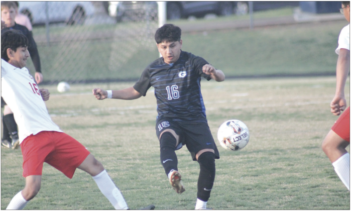 Guthrie's Adrian Gonzalez fights for a ball against Del City, March 31. Photo by George McCormick.