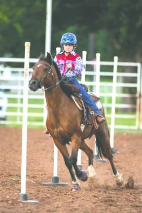 Margaret Boulter of Minco competes in the pole bending event during the Guthrie Youth Rodeo on Saturday at the Logan County Fairgrounds.