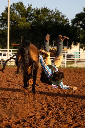 Kayden Ross of Altus is thrown from his bull and lands on his back during the junior bull riding event at the Guthrie Youth Rodeo on Saturday at the Logan County Fairgrounds.
