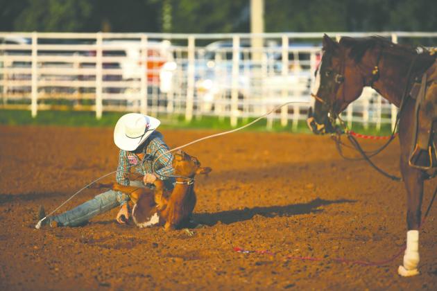 Blaze Fallis ties a calf’s hooves during the calf roping event at the Guthrie Youth Rodeo on Saturday at the Logan County Fairgrounds.