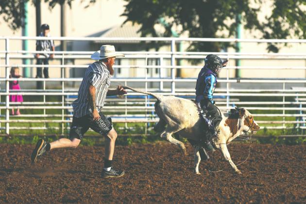 Barret Patton holds on during a long ride in the calf riding event at the Guthrie Youth Rodeo on Saturday at the Logan County Fairgrounds. He went on to win the event.