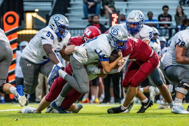Guthrie Running back Elijah Smith tries to spin away from Tuttle tacklers during the Bluejays' 38-13 seasoning-opening loss Thursday.