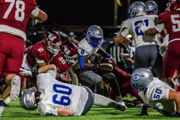 Guthrie quarterback Daelon Rice stretches for extra yardage as Tuttle defenders bring him to the ground. Guthrie players Sir'William Morgan(58) and Owen Wilder (78) are in on the play. Tuttle won 38-13