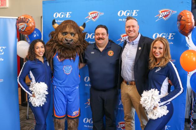 Guthrie Fire and EMS Captain Ryan Reeves poses with Guthrie Mayor Adam Ropp, Rumble and Oklahoma City Thunder cheerleaders during a ceremony recognizing Reeves for his ongoing commitment to public safety and community service. Photo courtesy of City of Guthrie