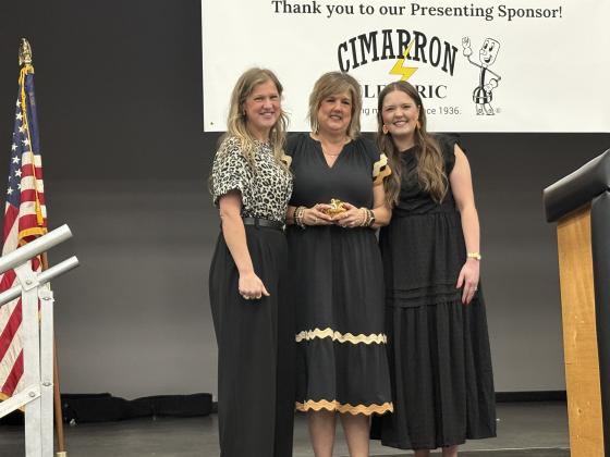 Dawn Wilson, pictured with her daughters Macy Barber and Meghan Wilson, was honored for her longtime commitment to Crescent students.