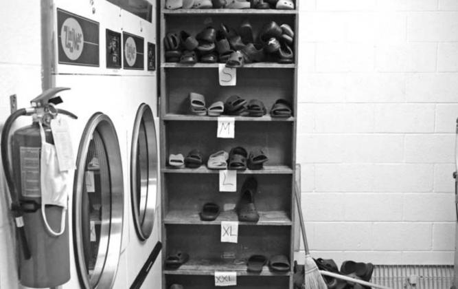 Shoe Rack next to dryer in the Detention Center.