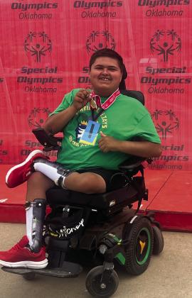 Team Guthrie’s Elijah Robles won a gold medal in the 30-meter wheelchair slalom race and a bronze medal in the 100-meter wheelchair race at the Special Olympics Summer Games in Stillwater. Photo submitted by Laura Benham.