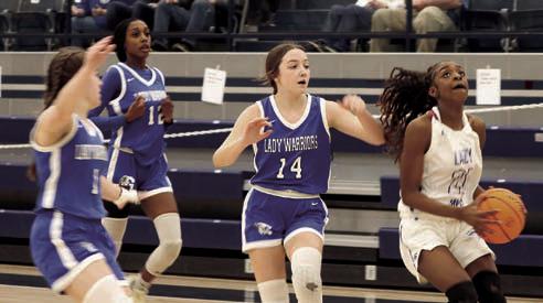 Ania Morgan with Glenpool players in pursuit. Photo by Mike Monahan.