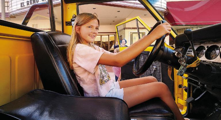 Tatum Eisenhour of El Reno checks out the inside of the Jeep during a photo stop in front of the Centre Theatre in downtown El Reno. (El Reno Tribune photographer/ Glen Miller)