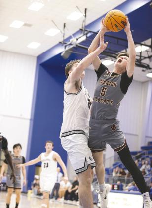 Cashion’s KyleYowell (5) attempts a shot against Minco during a Class 2A boysstate tournament game Saturday at Bridge Creek High School in Blanchard, Okla. Mincodefeated Cashion 75-46