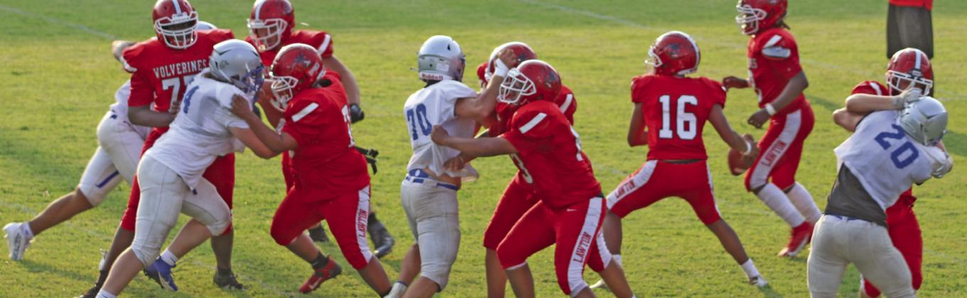 Guthrie Defense puts pressure on Lawton quarterback.