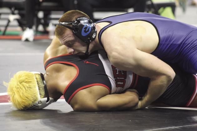 Guthrie's Bryson Hall wrestles Duncan's Izaya Elix in the 175-pound semifinal match at the 5A State Championships. Photo by George McCormick.