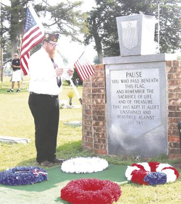 Kody Ellis of VFW with flag at Memory Gardens.