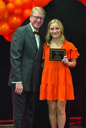 Reagan Carey accepts the Top Ten Freshmen Women award from OSU President, Dr. Jim Hess. Photo Submitted.