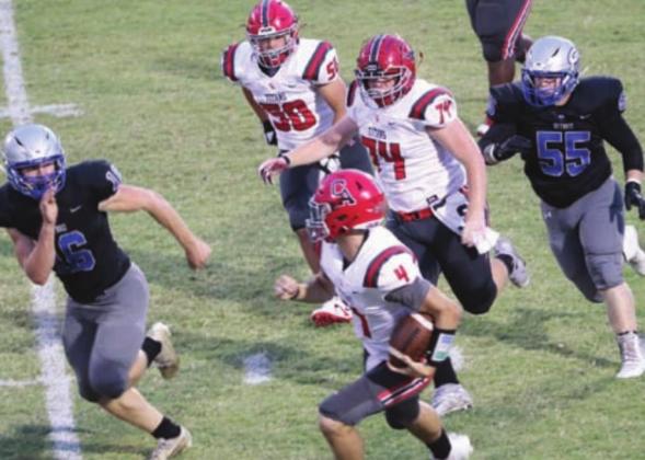 Jacob Varnell and Gavin Selanders give chase after Carl Albert quarterback